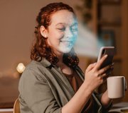 Woman with phone face scan &mdash; live capture